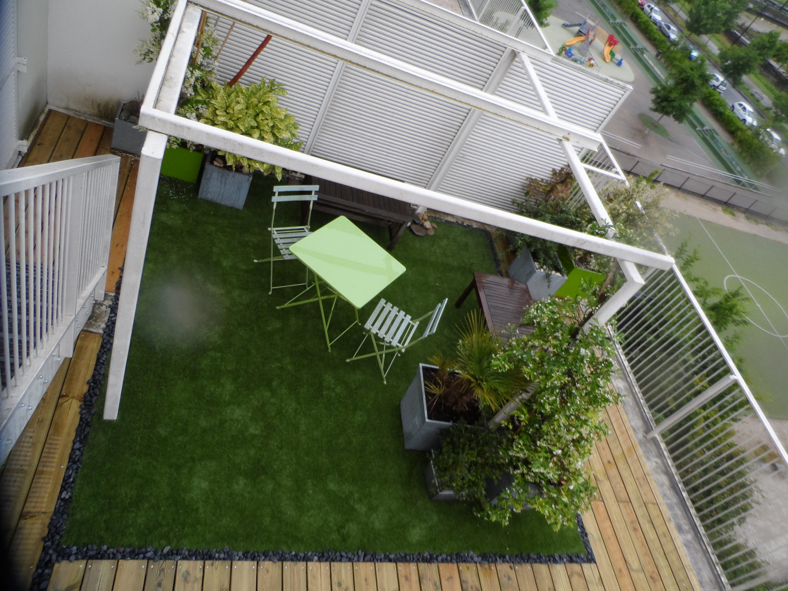 Inclusion de gazon synthétique dans une terrasse en pin